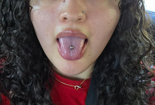 A centered tongue piercing with a titanium stud by Stevo at Golden Tarot Ink Club